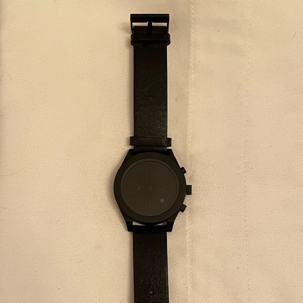 Aark Collective black leather watch.